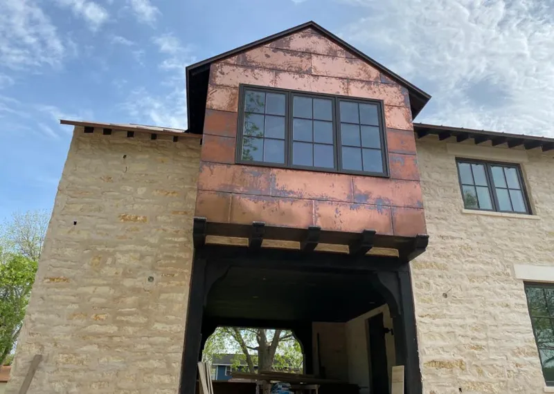 Copper metal panel facade on a stone building for Roof Repair in Burkburnett